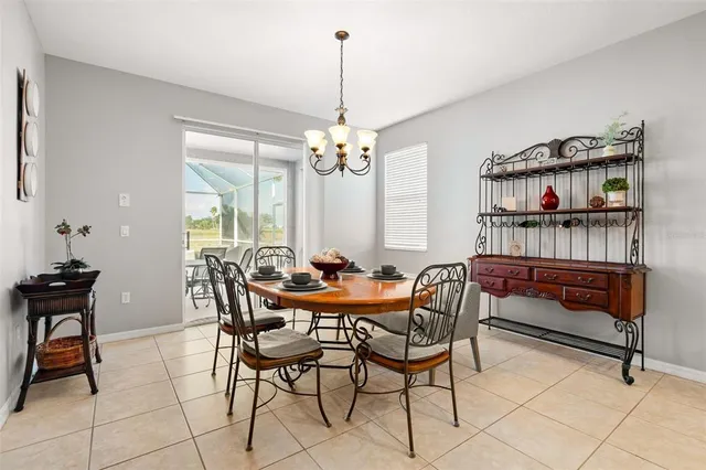 a view of a dining room with furniture and a chandelier
