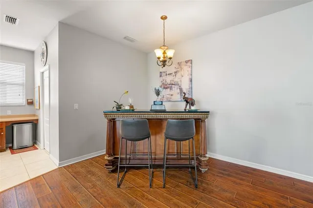 a view of a dining room with furniture wooden floor and a chandelier