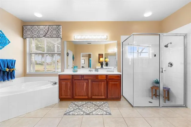 a bathroom with a tub a sink and mirrors