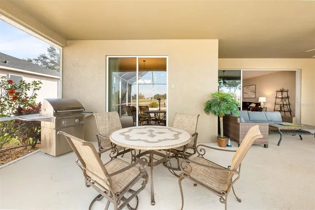 a living room with furniture a dining table and a potted plant