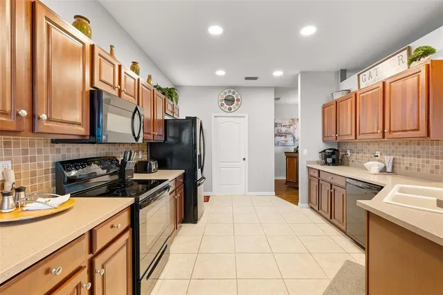 a kitchen with a sink a refrigerator and cabinets