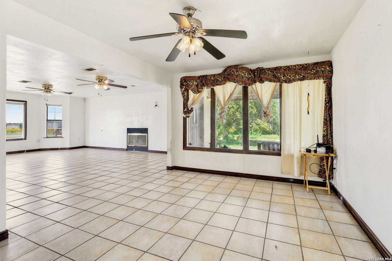 3061 Horse Ranch Road San Antonio, TX 78264 - Photo 8 of 34 a view of an empty room with a window and a kitchen view