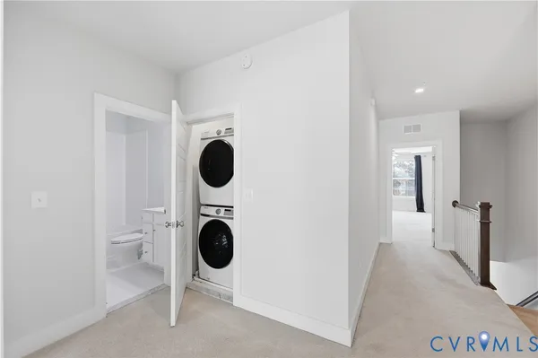 a view of a hallway with washer and dryer