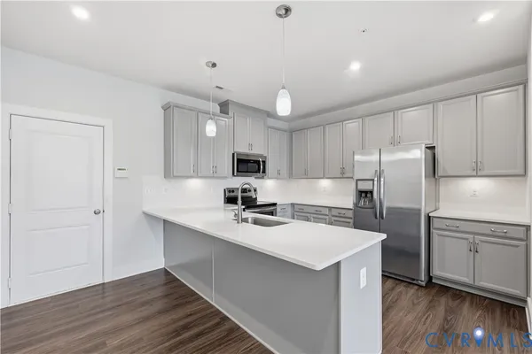 a kitchen with refrigerator cabinets and wooden floor