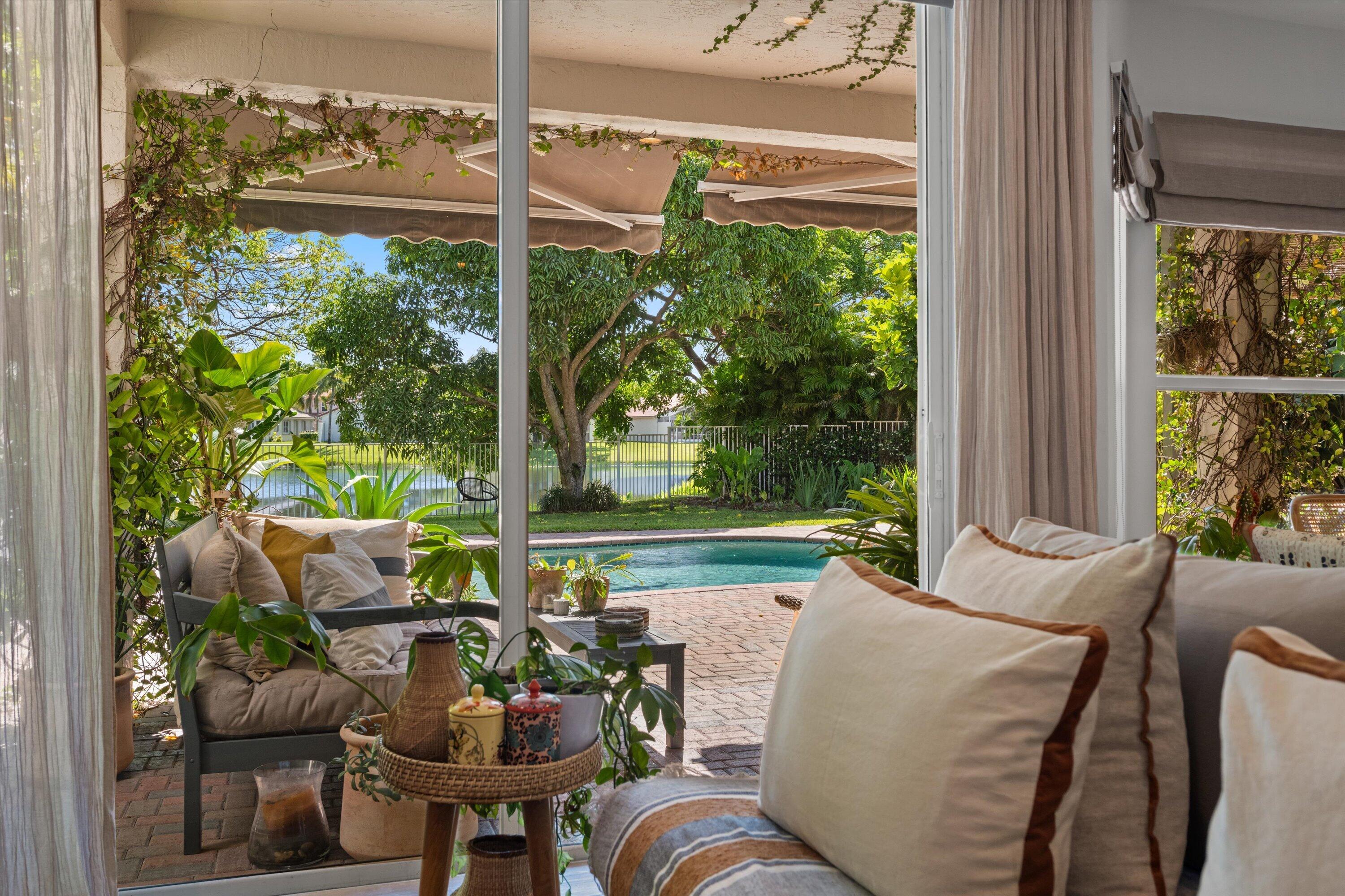 4138 Bluff Harbor Way Wellington, FL 33449 - Photo 1 of 48 a view of a patio with couches table and chairs and potted plants