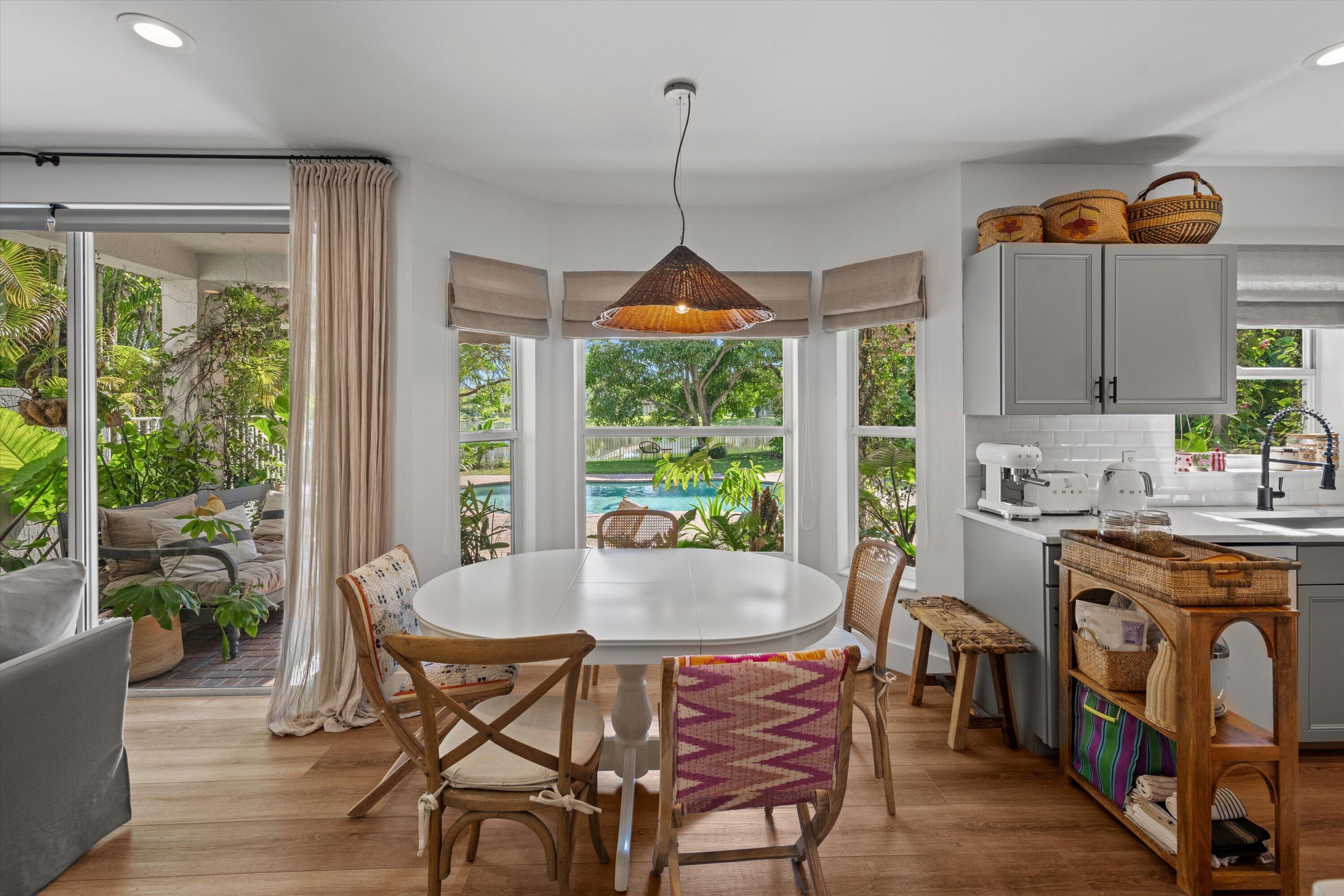 4138 Bluff Harbor Way Wellington, FL 33449 - Photo 13 of 48 a dining room with furniture window wooden floor