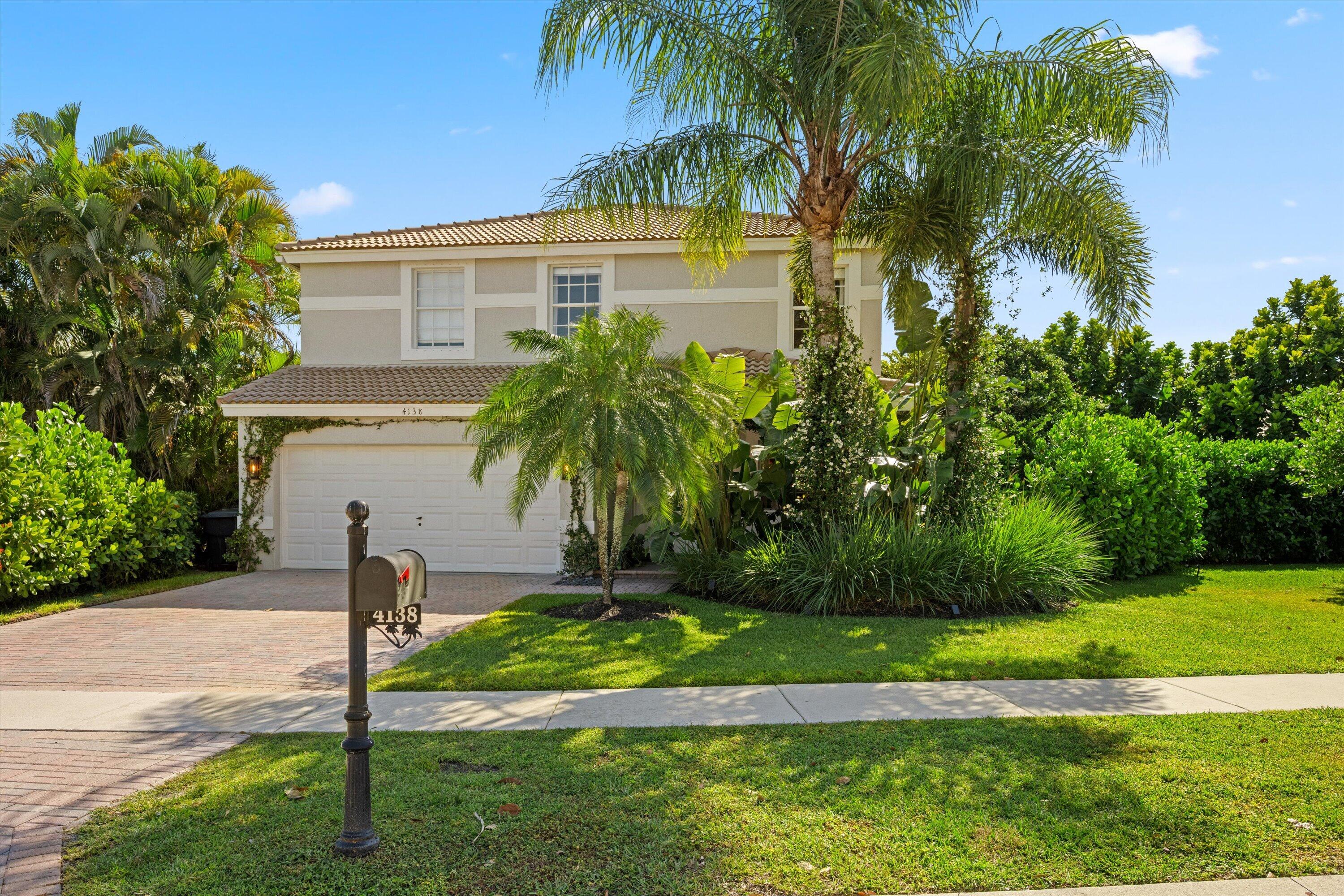 4138 Bluff Harbor Way Wellington, FL 33449 - Photo 3 of 48 a front view of a house with a yard