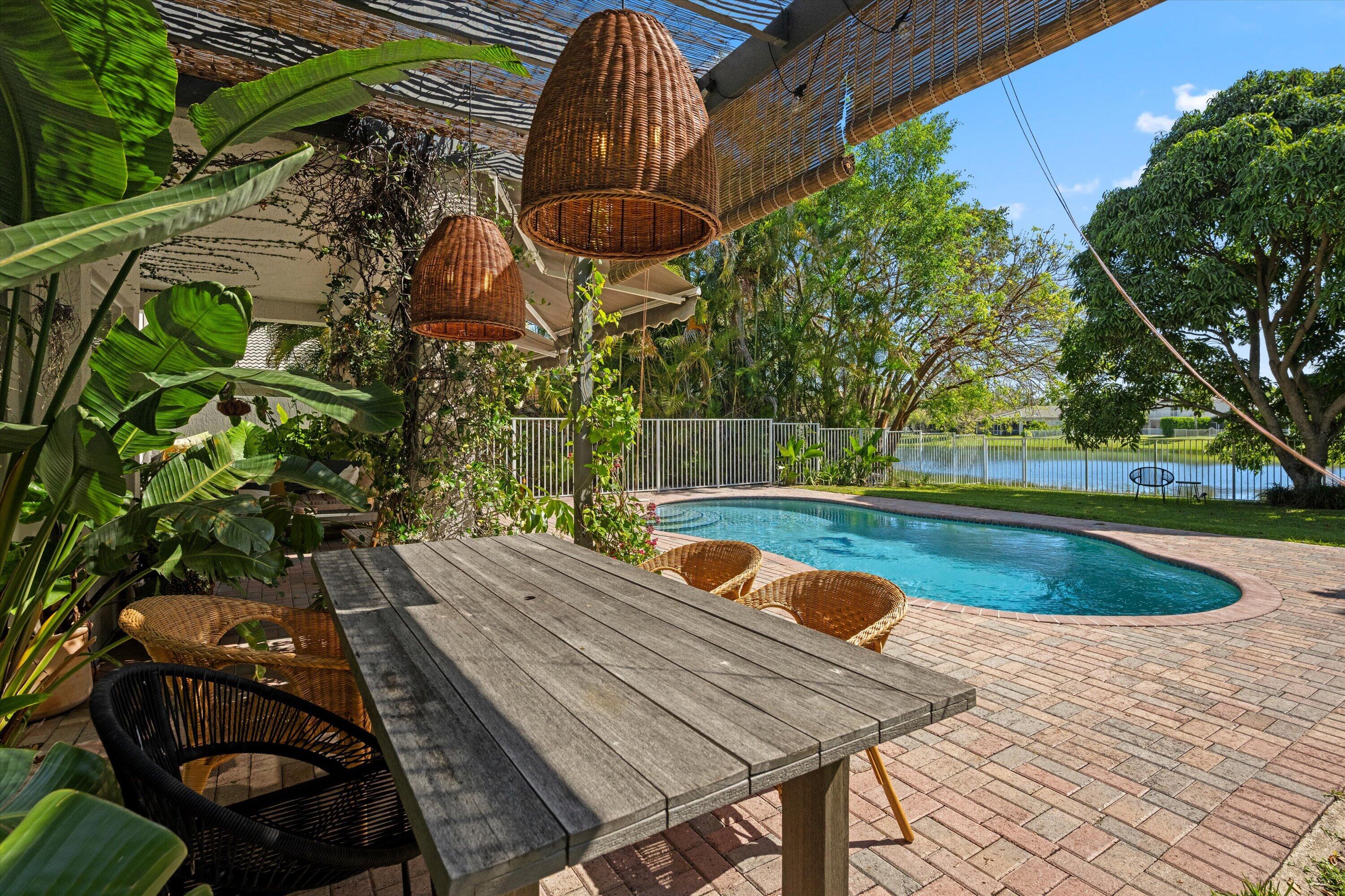 4138 Bluff Harbor Way Wellington, FL 33449 - Photo 34 of 48 a view of backyard with swimming pool and outdoor seating