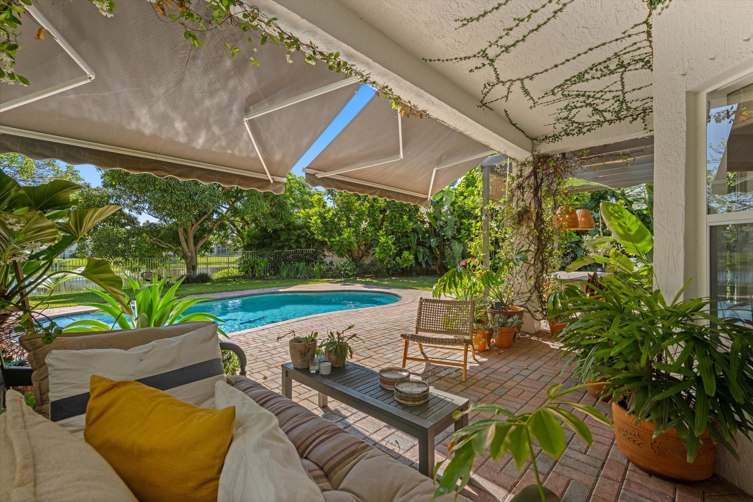 4138 Bluff Harbor Way Wellington, FL 33449 - Photo 35 of 48 a view of a patio with couches table and chairs potted plants