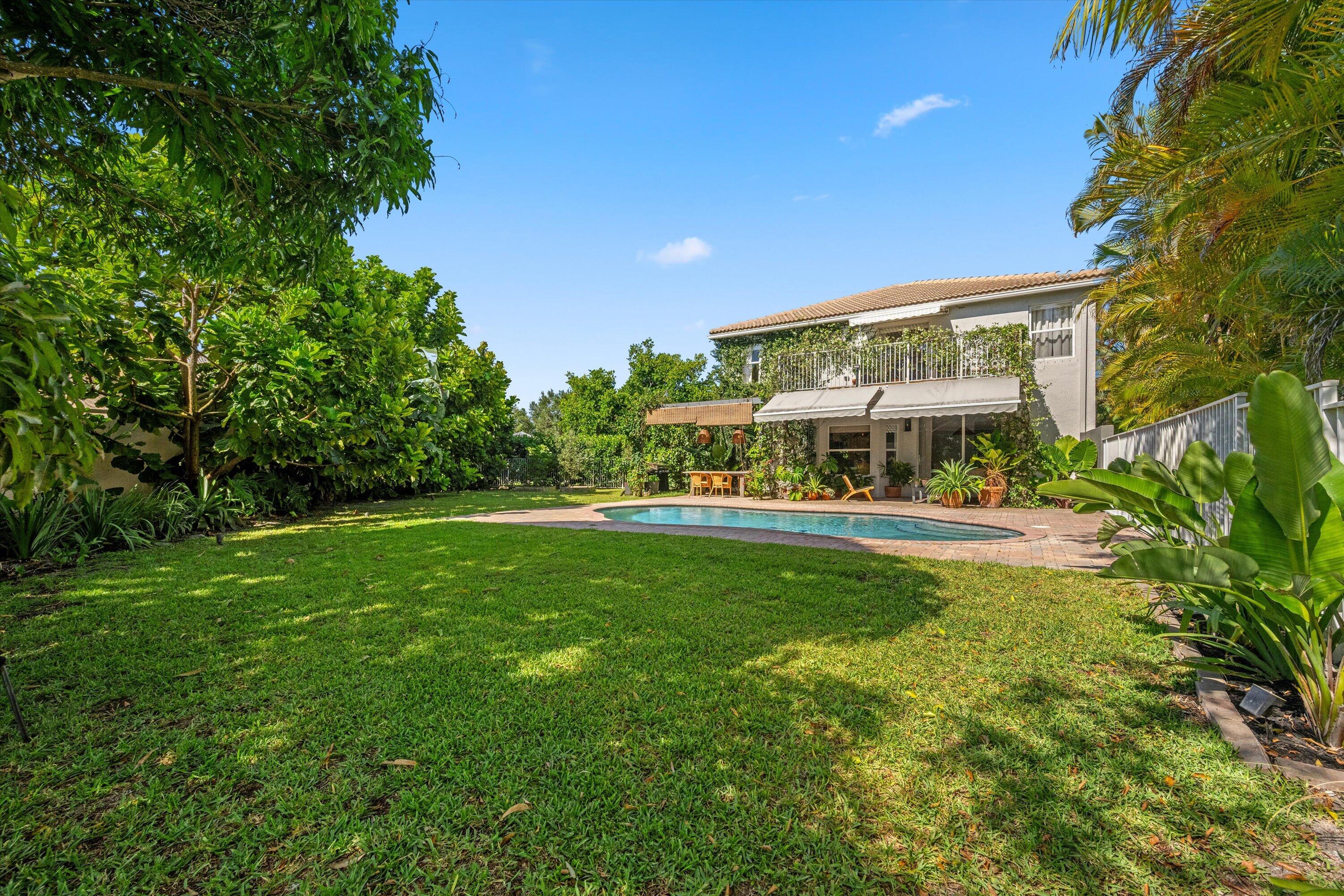 4138 Bluff Harbor Way Wellington, FL 33449 - Photo 39 of 48 a view of house with garden and sitting area