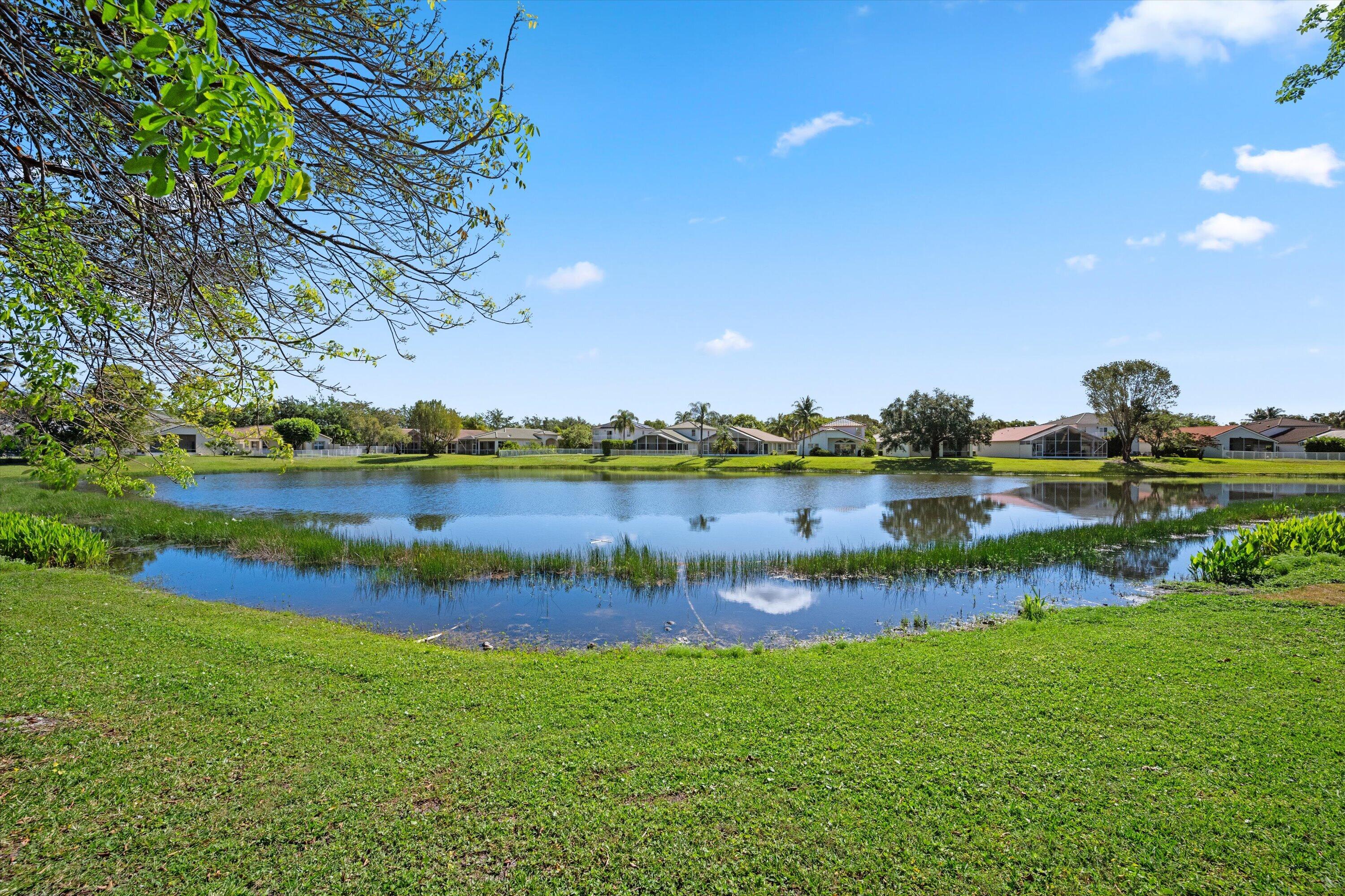 4138 Bluff Harbor Way Wellington, FL 33449 - Photo 41 of 48 a view of a lake with houses in the back