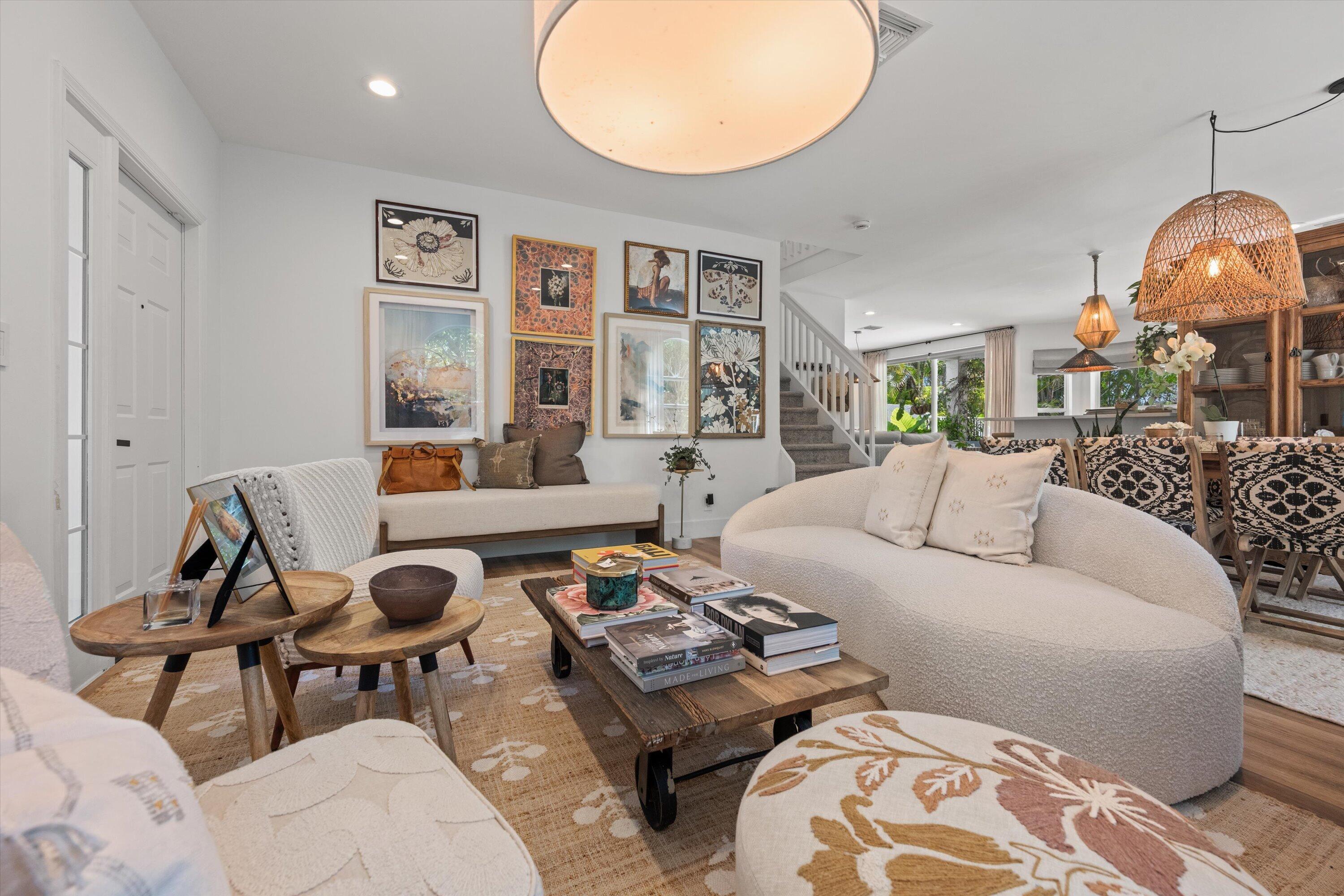 4138 Bluff Harbor Way Wellington, FL 33449 - Photo 5 of 48 a living room with furniture a wooden floor and a chandelier