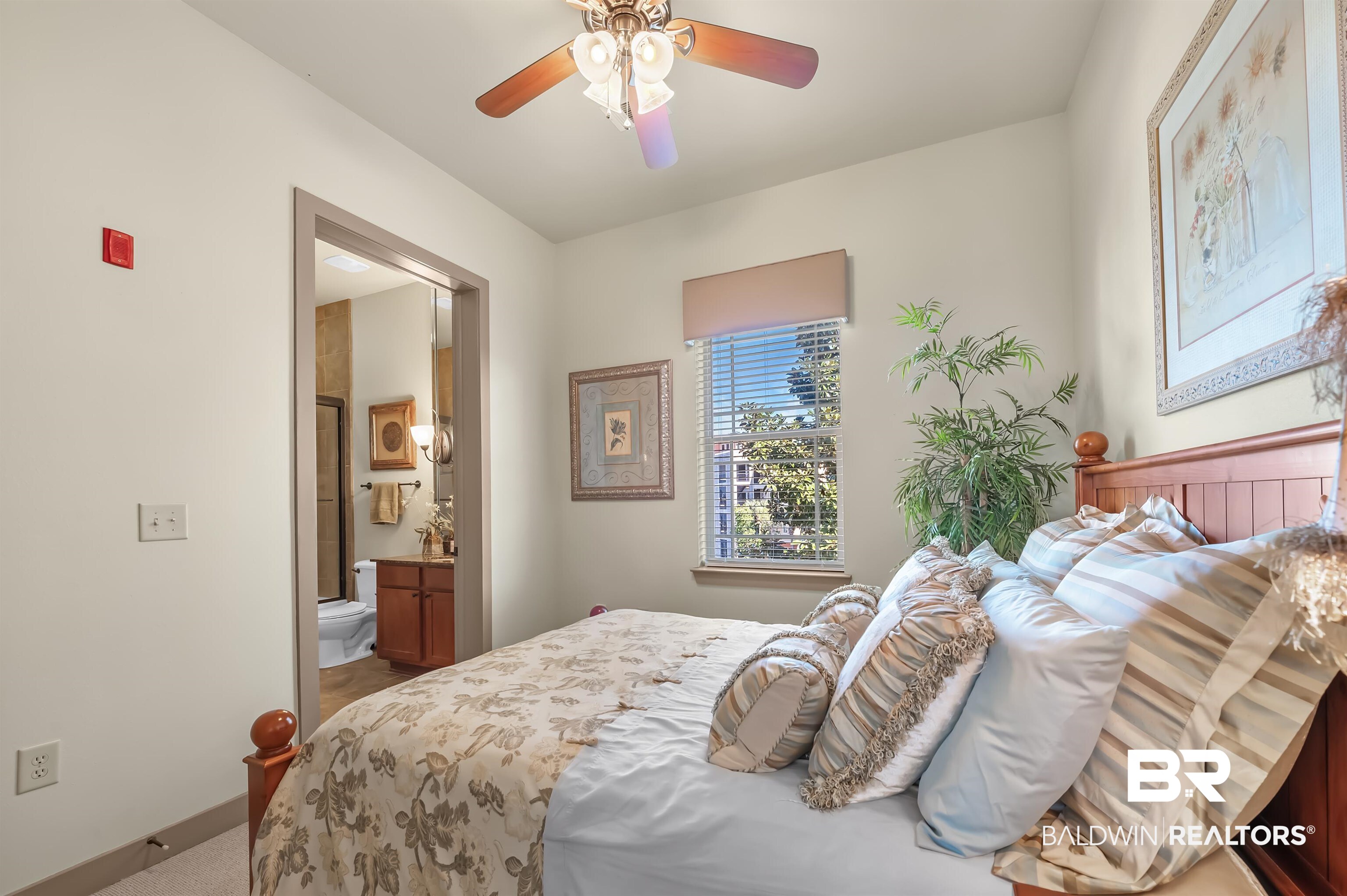 1430 Regency Road, Unit A301 Gulf Shores, AL 36542 - Photo 28 of 47 Bedroom featuring ceiling fan, carpet flooring, and ensuite bath