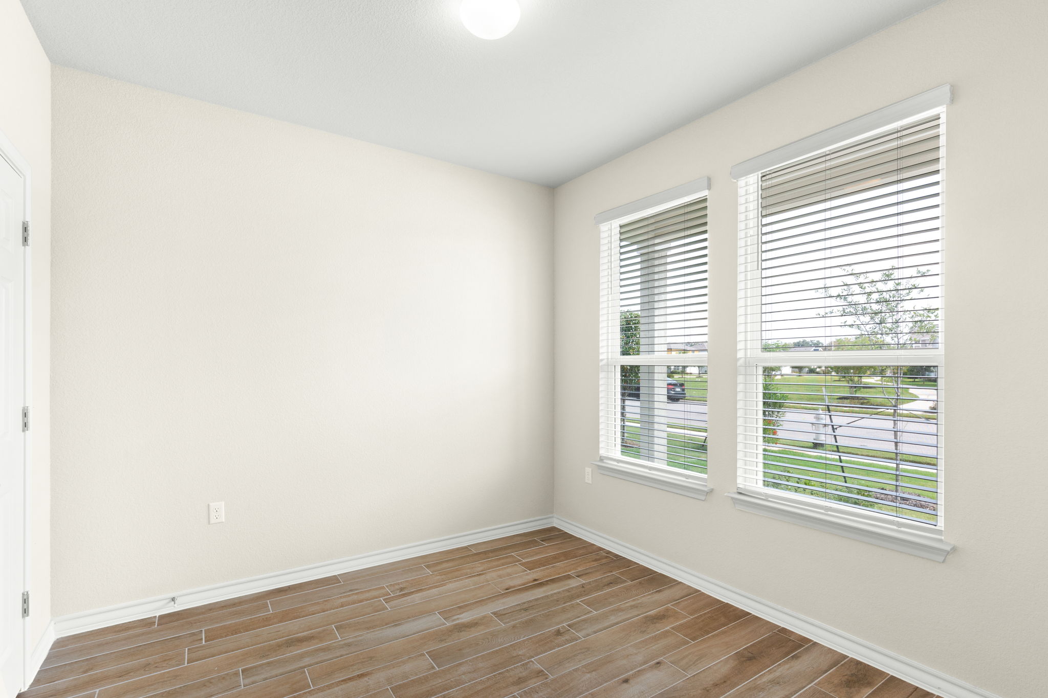 1624 Caballo Blanco Road Austin, TX 78725 - Photo 5 of 27 Generous windows fill this versatile space with natural light highlighting the wood-look tile flooring.