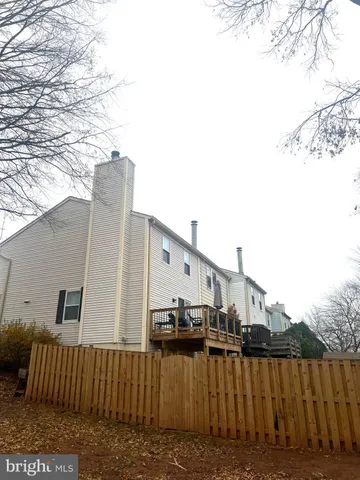 a view of a house with wooden fence