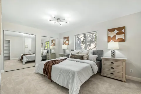 a spacious bedroom with two beds and a chandelier