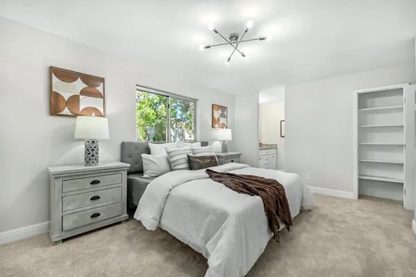 a bed room with bed and a night stand