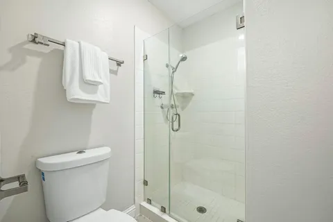 a bathroom with a shower toilet and sink