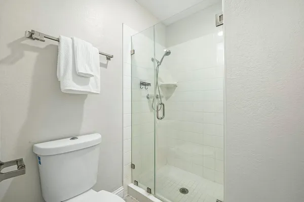 a bathroom with a shower toilet and sink
