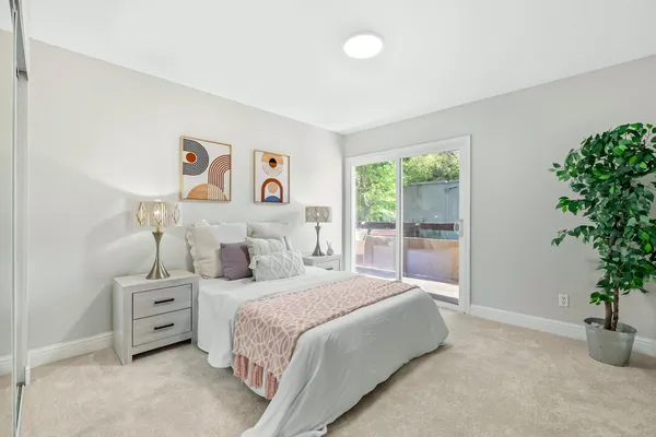 a bedroom with a bed and a potted plant