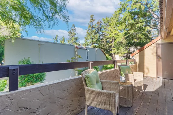 a view of backyard with outdoor seating and wooden fence