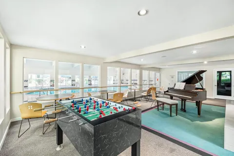 a living room with furniture and a floor to ceiling window