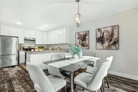 a view of kitchen with refrigerator dining table and chairs