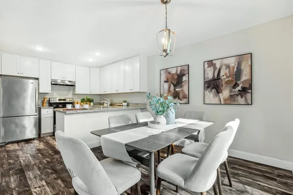 a view of kitchen with refrigerator dining table and chairs