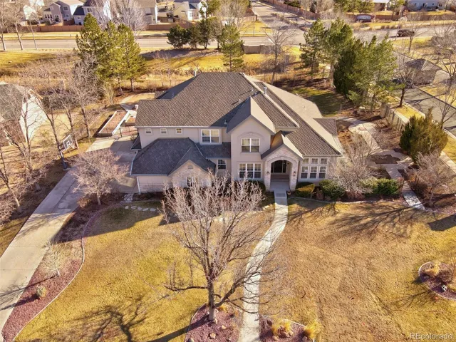 a view of a house with a yard covered with snow