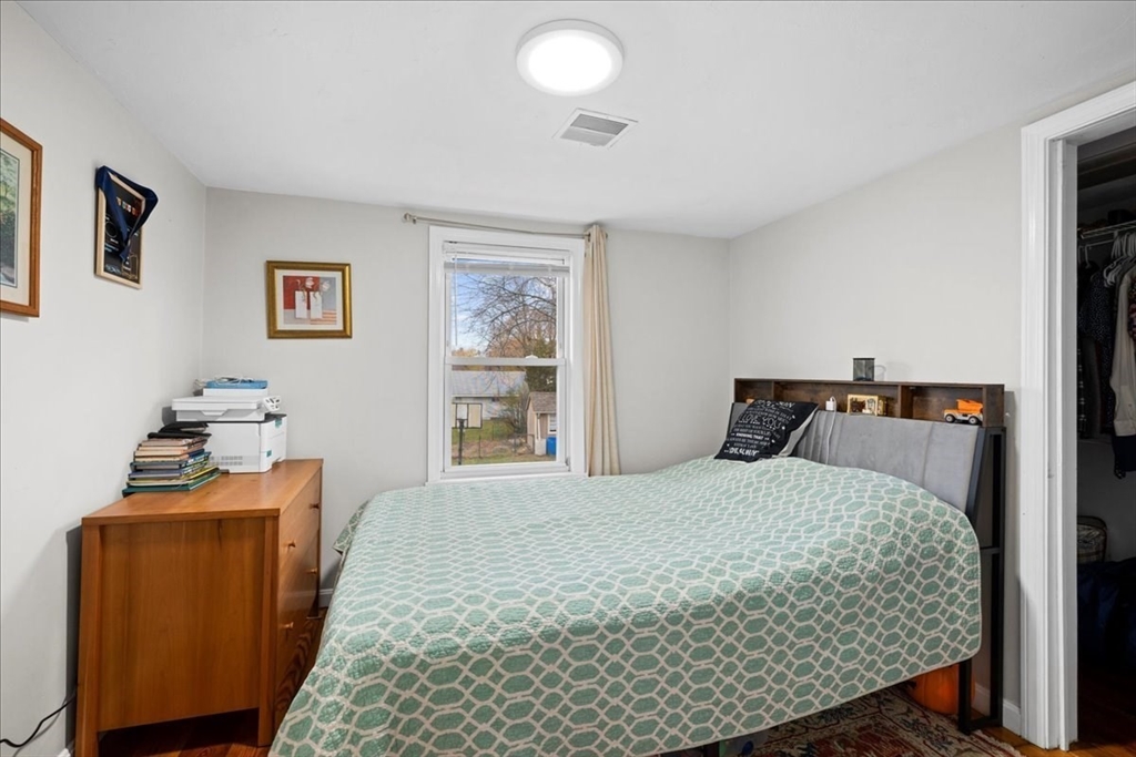 65 Edgewater Avenue Shrewsbury, MA 01545 - Photo 14 of 35 a bedroom with a bed and wooden floor