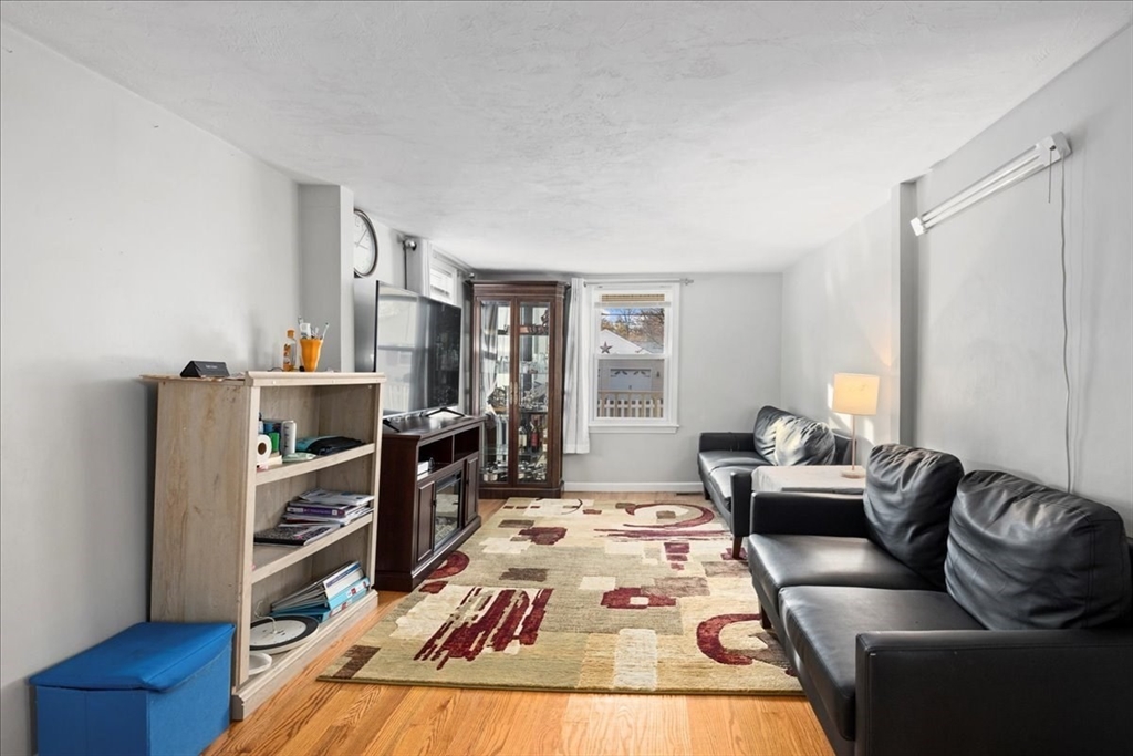 65 Edgewater Avenue Shrewsbury, MA 01545 - Photo 8 of 35 a living room with furniture and a wooden floor