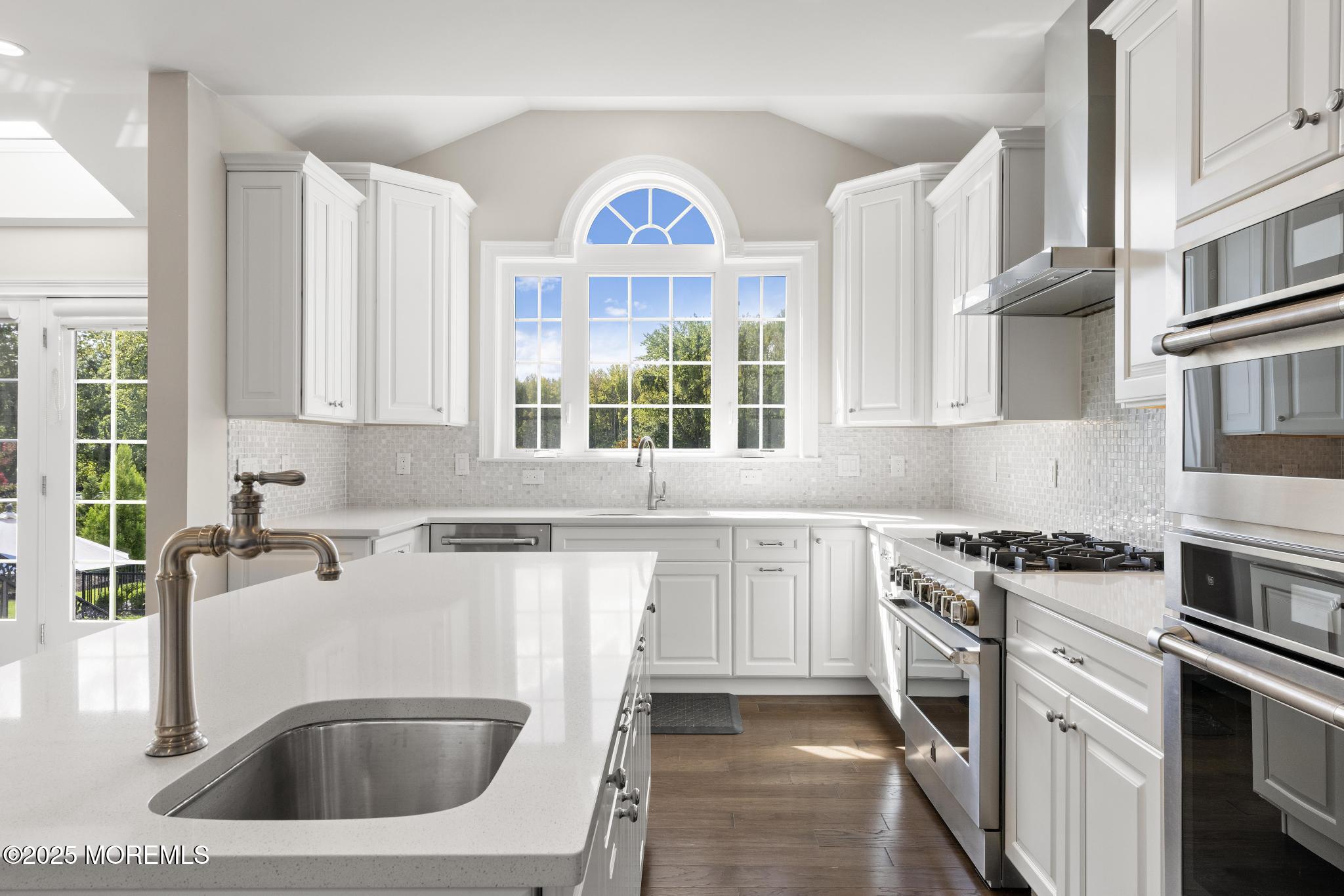 45 Windermere Road Lincroft, NJ 07738 - Photo 11 of 68 a kitchen with stainless steel appliances granite countertop a sink stove and cabinets
