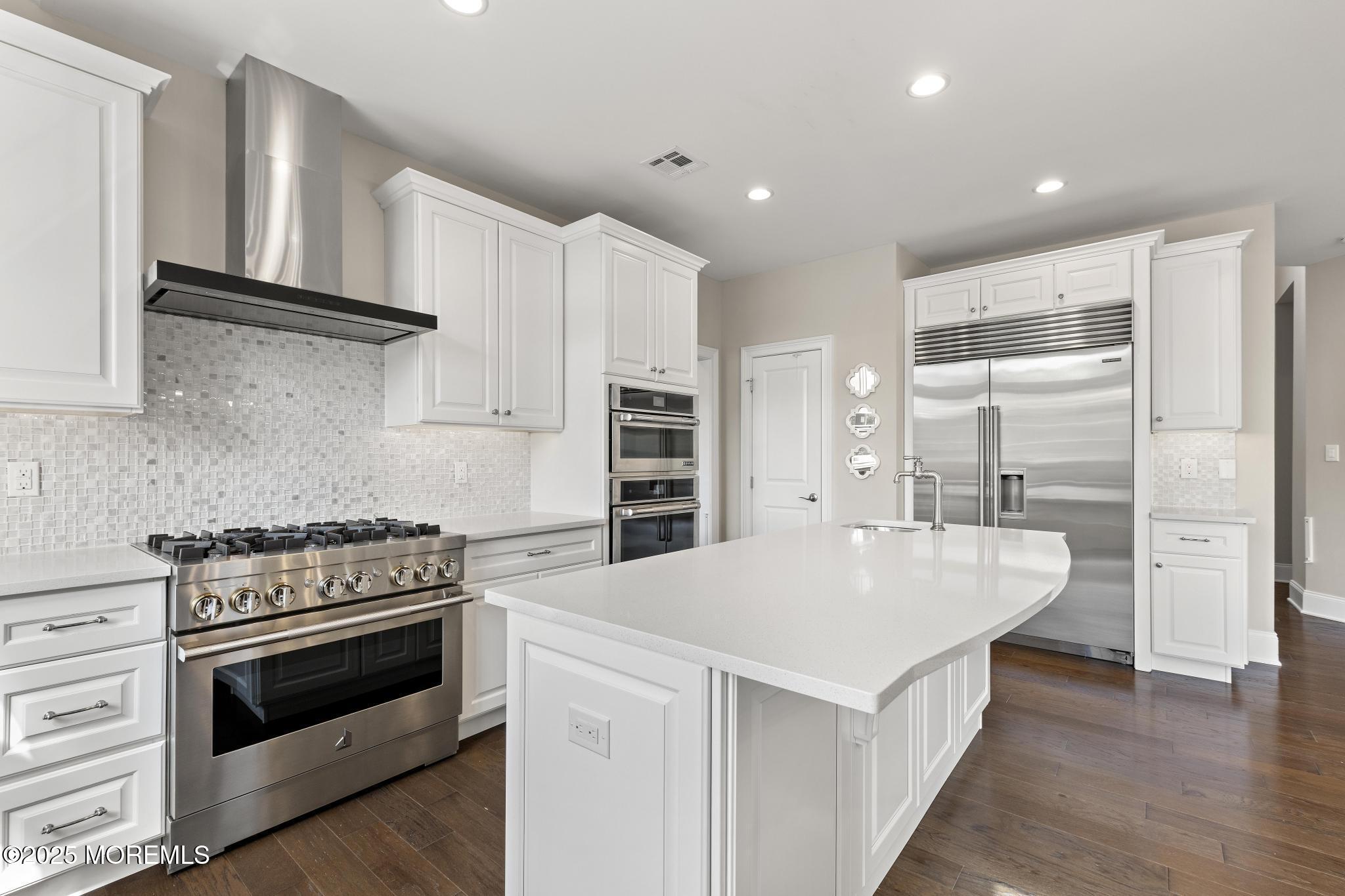 45 Windermere Road Lincroft, NJ 07738 - Photo 12 of 68 a kitchen with white cabinets and stainless steel appliances