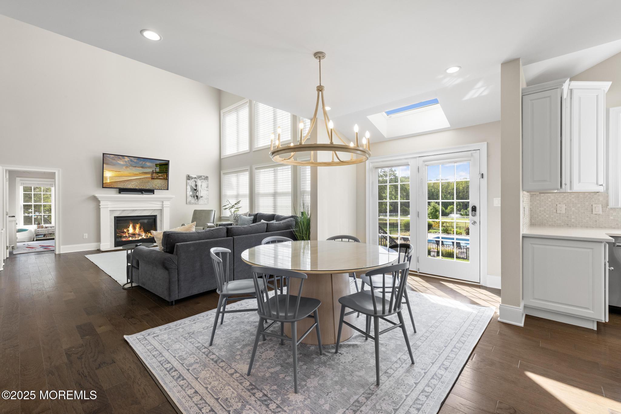 45 Windermere Road Lincroft, NJ 07738 - Photo 14 of 68 a dining room with furniture a chandelier and wooden floor