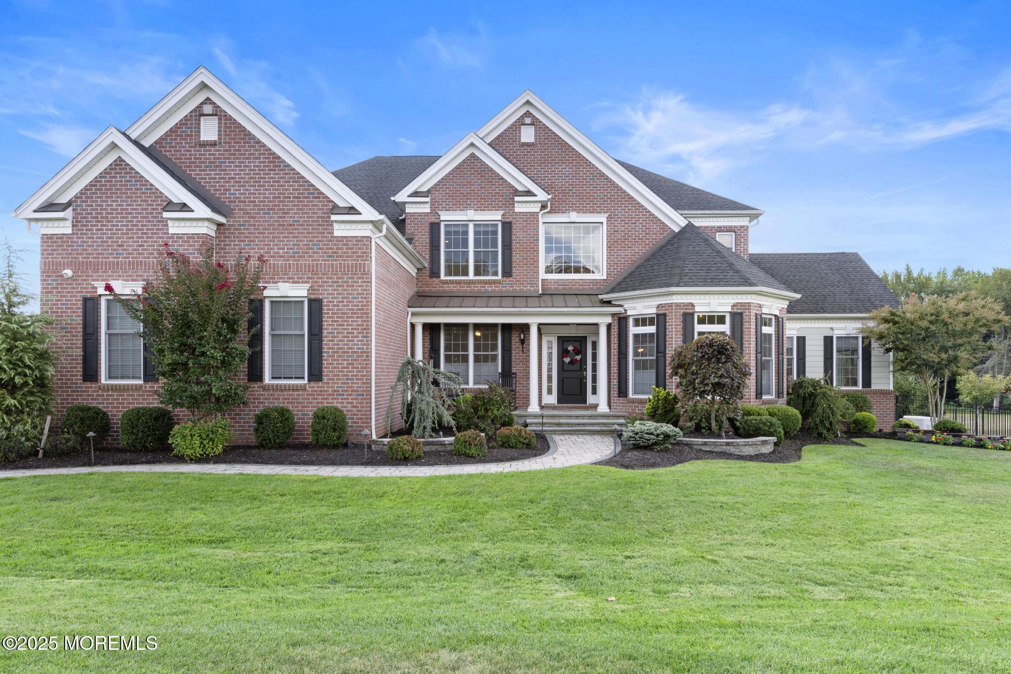 45 Windermere Road Lincroft, NJ 07738 - Photo 2 of 68 a front view of a house with a yard and potted plants