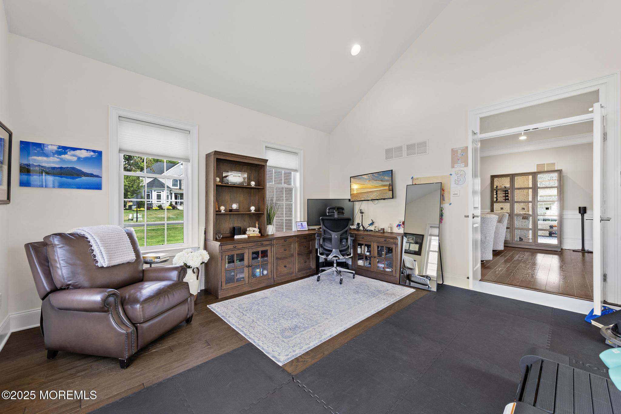 45 Windermere Road Lincroft, NJ 07738 - Photo 25 of 68 a living room with furniture and a flat screen tv with wooden floor