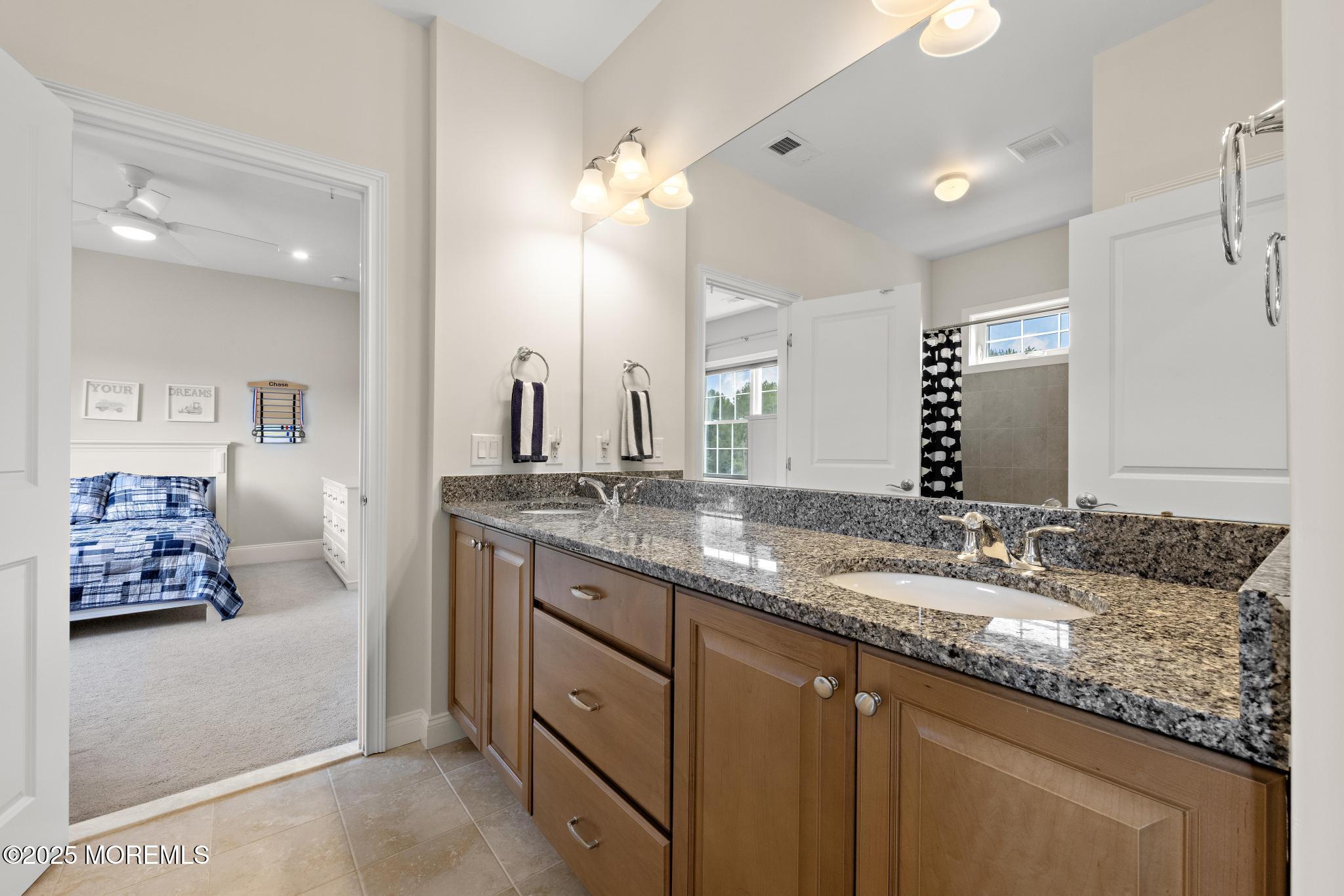 45 Windermere Road Lincroft, NJ 07738 - Photo 41 of 68 a bathroom with double vanity sinks a large mirror and a shower