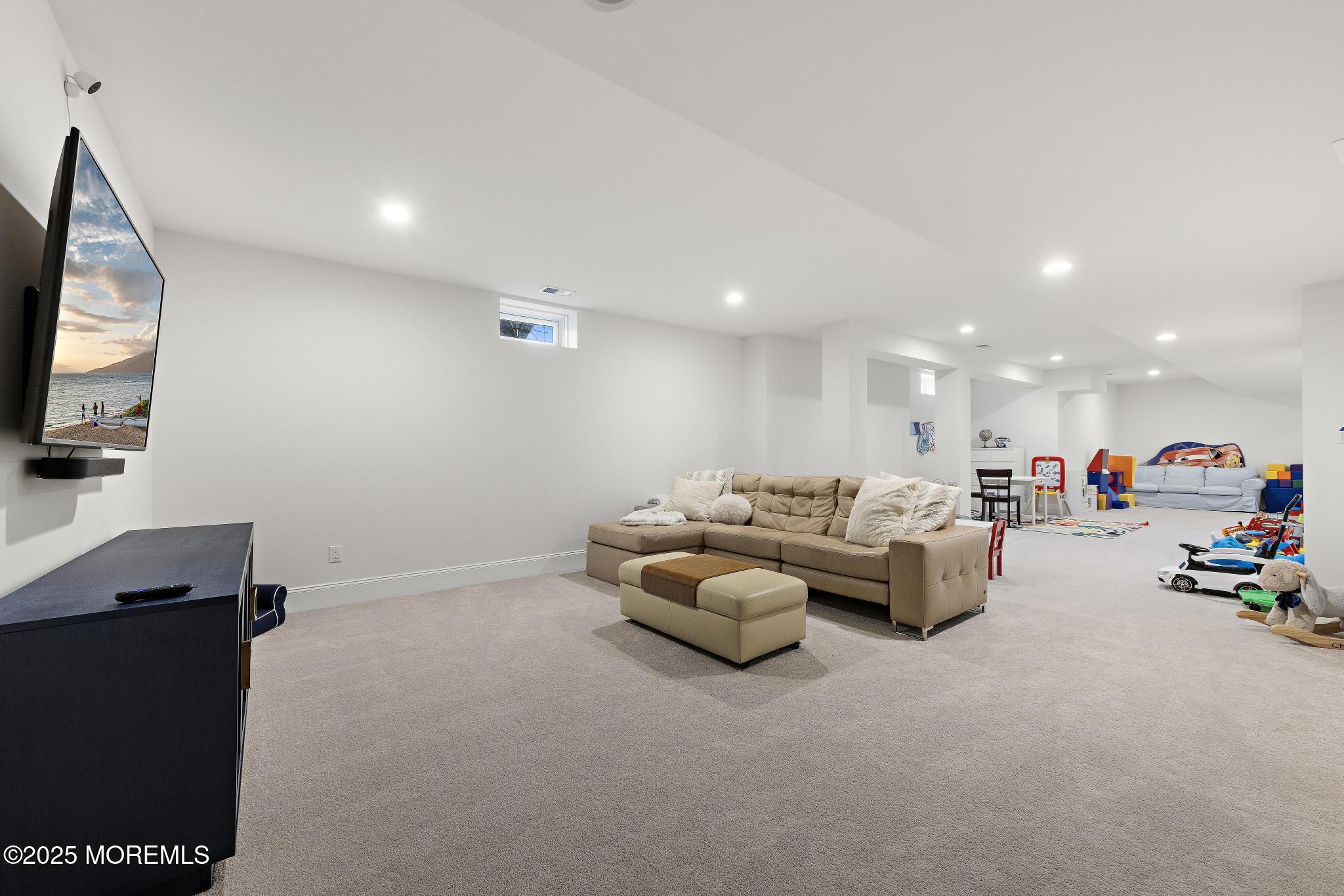 45 Windermere Road Lincroft, NJ 07738 - Photo 46 of 68 a living room with furniture and a flat screen tv