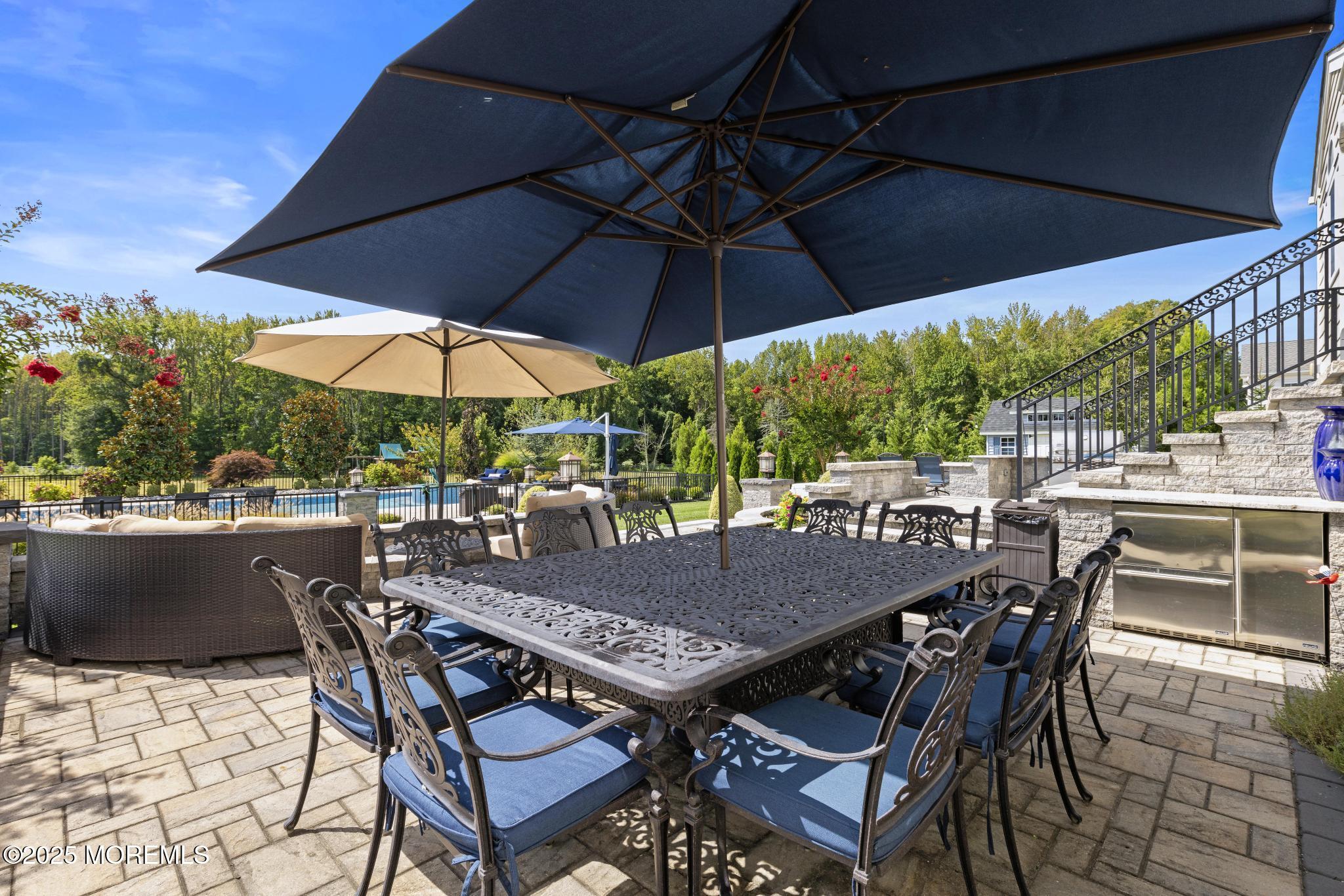 45 Windermere Road Lincroft, NJ 07738 - Photo 55 of 68 a view of an outdoor space with furniture and umbrella