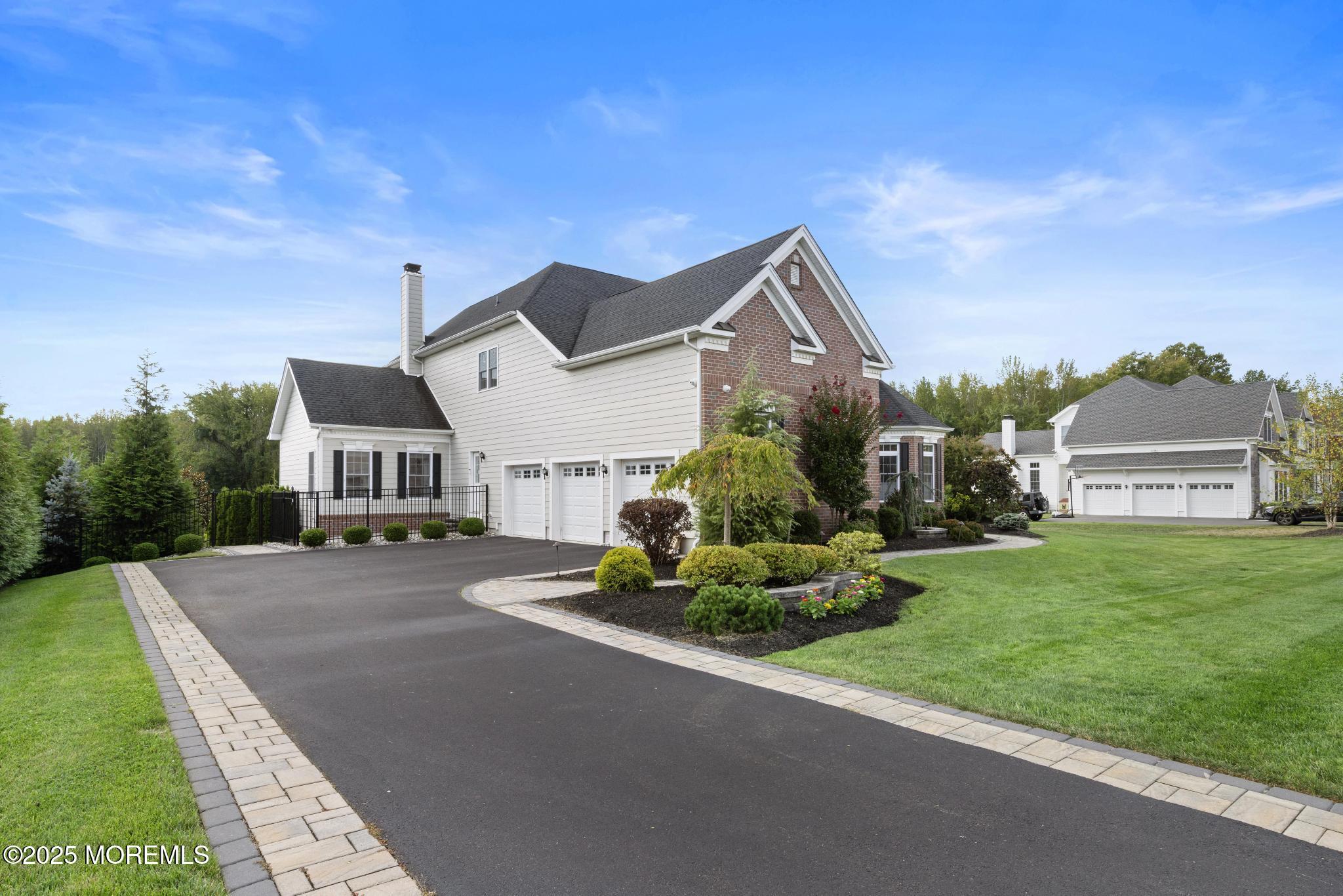 45 Windermere Road Lincroft, NJ 07738 - Photo 61 of 68 a front view of a house with a yard and a garage