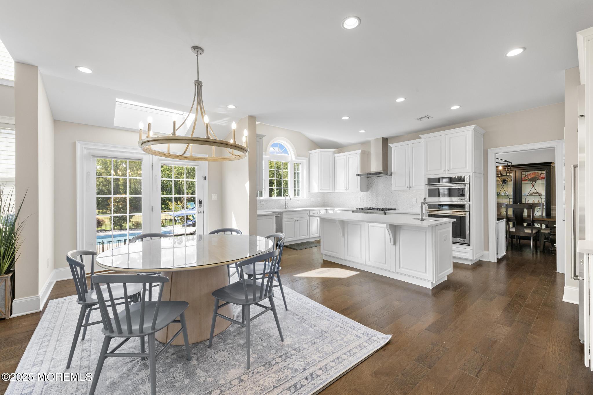 45 Windermere Road Lincroft, NJ 07738 - Photo 9 of 68 a view of a dining room and livingroom with furniture wooden floor kitchen chandelier