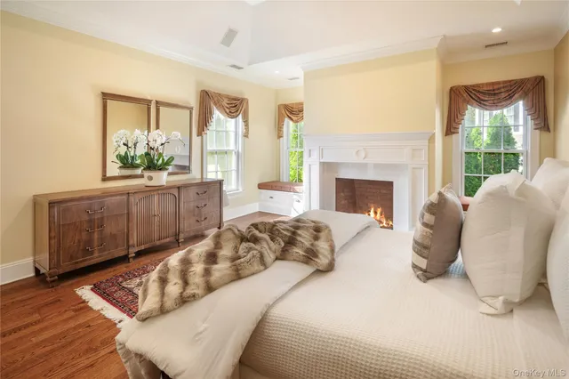 a bedroom with a large bed and a fireplace
