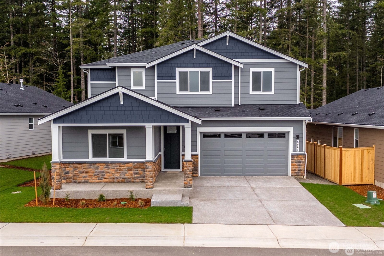 5904 Trce Drive Southwest Port Orchard, WA 98367 - Photo 1 of 29 a front view of a house with a yard and garage
