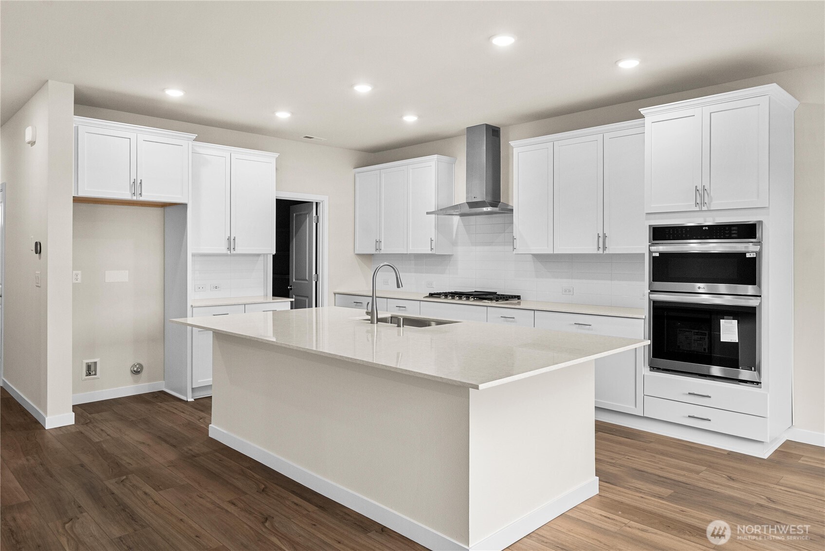 5904 Trce Drive Southwest Port Orchard, WA 98367 - Photo 11 of 29 a kitchen with kitchen island white cabinets and stainless steel appliances