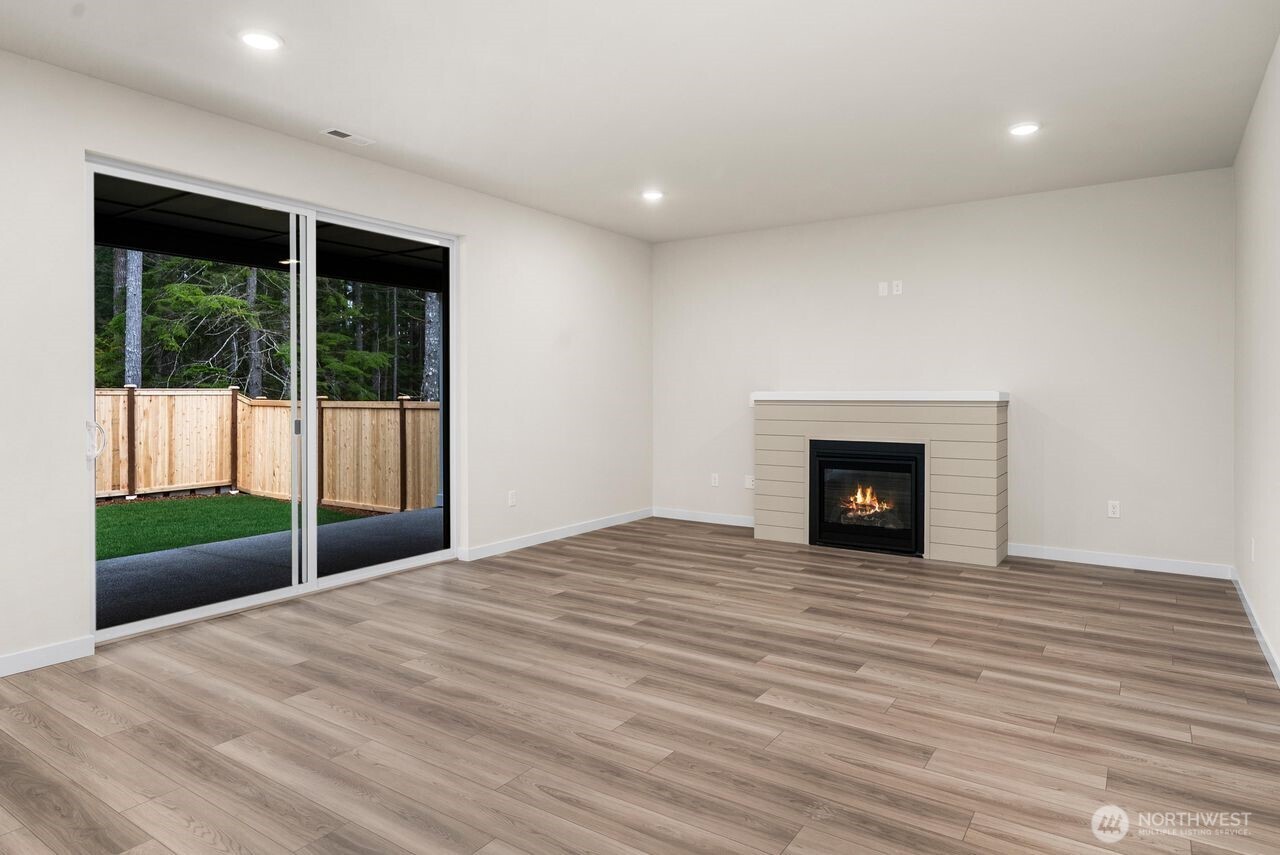 5904 Trce Drive Southwest Port Orchard, WA 98367 - Photo 15 of 29 a view of an empty room with a fireplace and a window