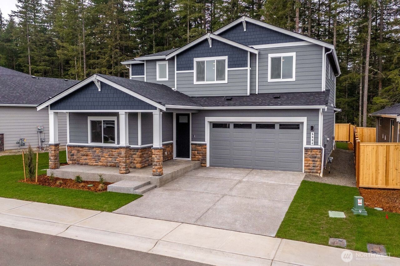 5904 Trce Drive Southwest Port Orchard, WA 98367 - Photo 2 of 29 a front view of a house with a yard and garage