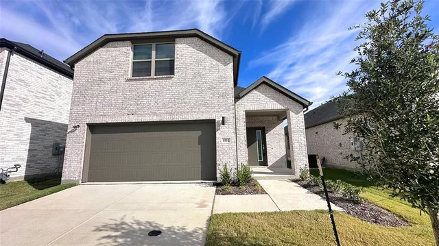 a front view of a house with parking