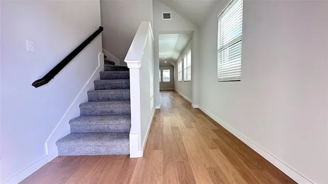 a view of entryway and hall with wooden floor