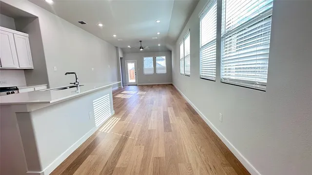 a spacious bathroom with a double vanity sink and a large mirror