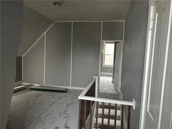 a view of a room with wooden floor and a window